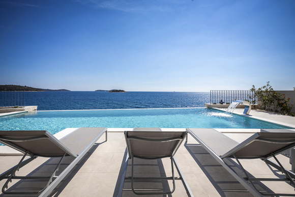 Beachfront holiday villa private pool at rocky beach Dalmatia Croatia